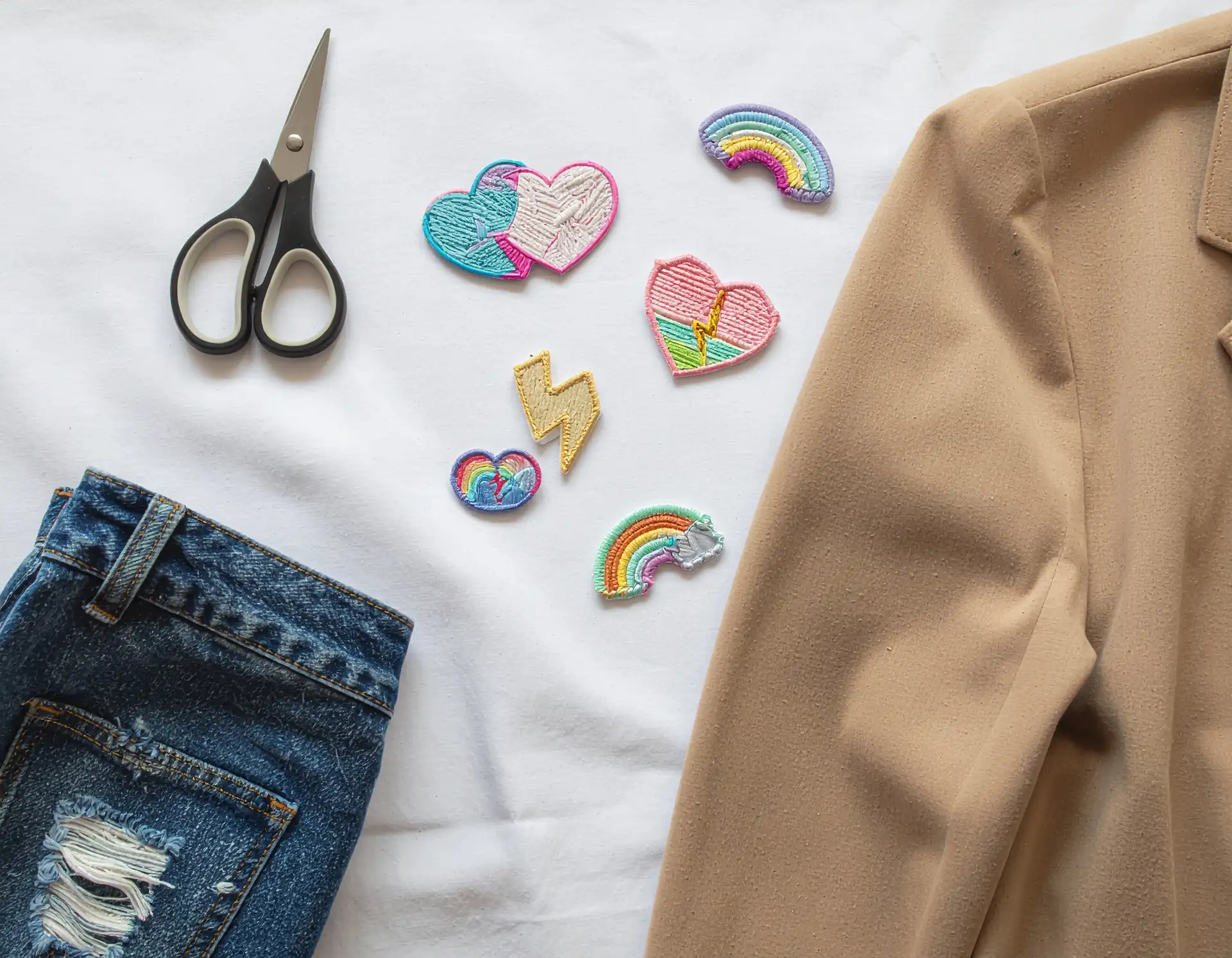 Flat-lay of DIY craft bar supplies — patches, beads, and chalkboards for a sleepover party
